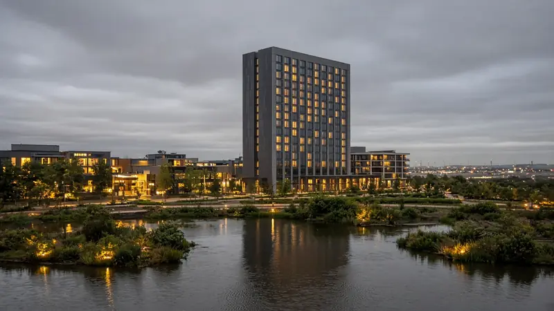 Illustration of a contemporary UK casino resort campus beside landscaped water
